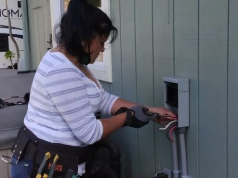 Licensed electrician wiring an exterior subpanel in Forks